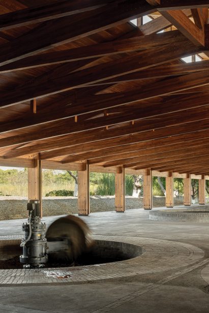 Pit for crushing agave under a wooden roof truss