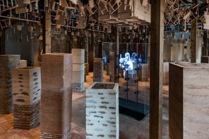 Photo of Morocco pavilion at the Venice Architecture Biennale showing a space filled with pillars made of different earthen materials