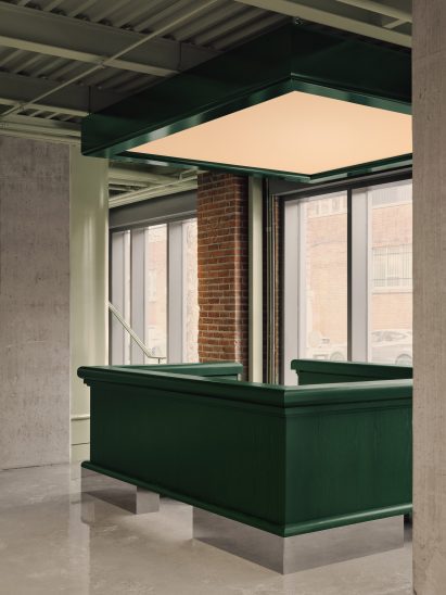 A reception desk made from dark green oak veneer