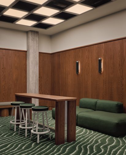 Red oak panelling and grassy carpet line a golf simulator lounge
