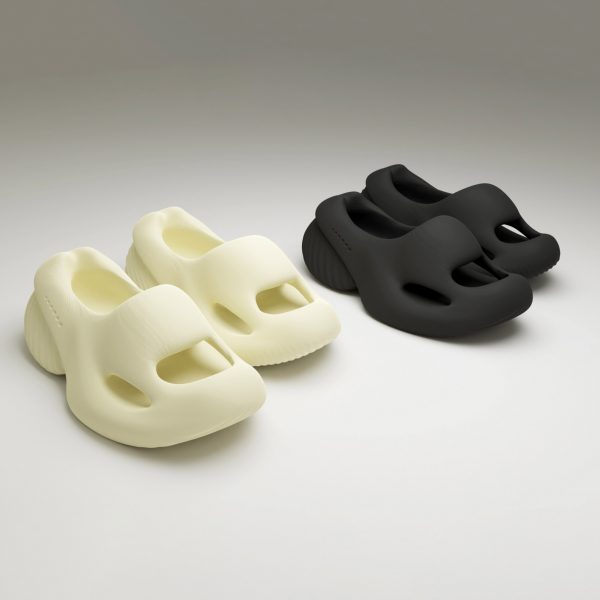 a photograph of two pairs of shoes next to each other, one in white and one in black
