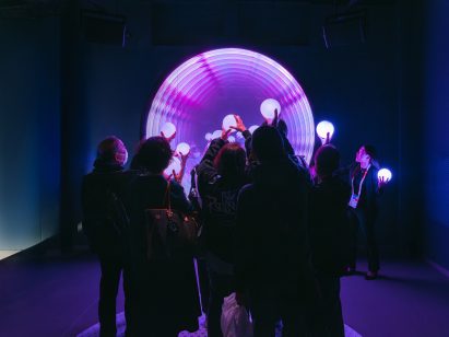 People holding orbs within exhibition space at Expo 2025 Osaka