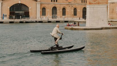 Norman Foster riding a water bike