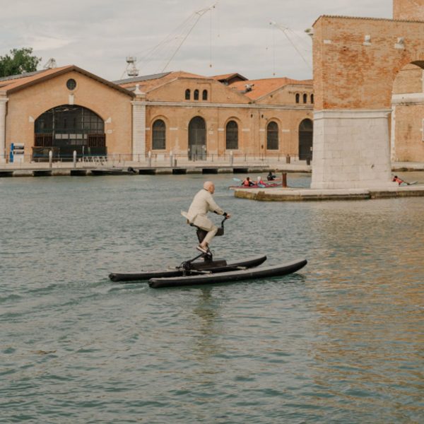 Norman Foster riding a water bike