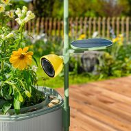 Photo of the Petal camera attached to the Wonder Blocks planter trellis overlooking some flowers