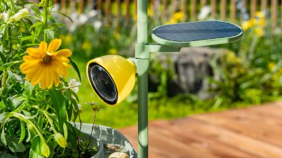 Photo of the Petal camera attached to the Wonder Blocks planter trellis overlooking some flowers