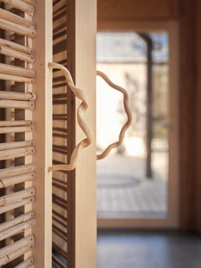 Curly clamatis wood door handles of Rooted Potential pavilion by Sara Martinsen