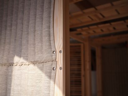 Eelgrass-stuffed linen walls of Rooted Potential pavilion by Sara Martinsen