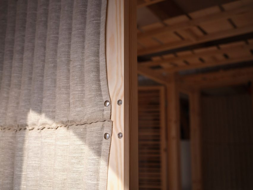 Eelgrass-stuffed linen walls of Rooted Potential pavilion by Sara Martinsen