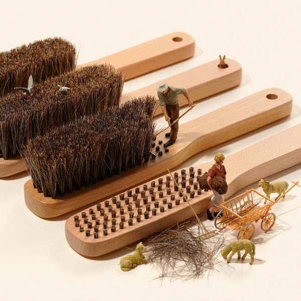 Miniature figures posed to look like they're harvesting fibres from a brush