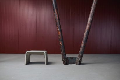 White recycled plastic stool in a red room
