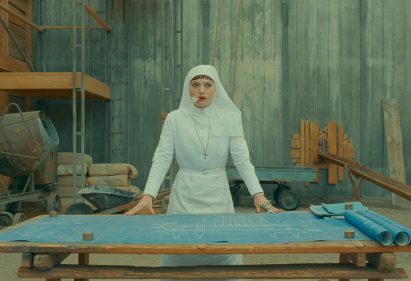 Sister Liesl standing over blueprint