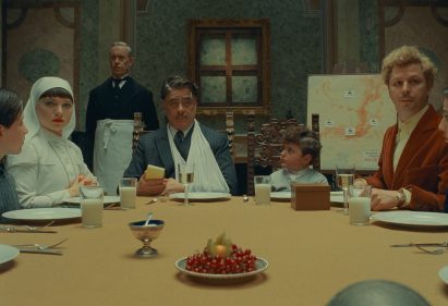 People sitting around table in The Phoenician Scheme