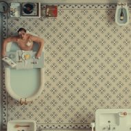 Man in bathtub on a tiled floor