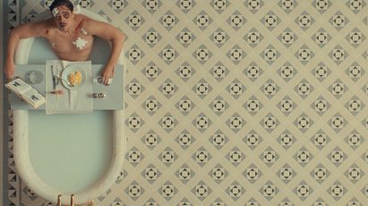 Man in bathtub on a tiled floor