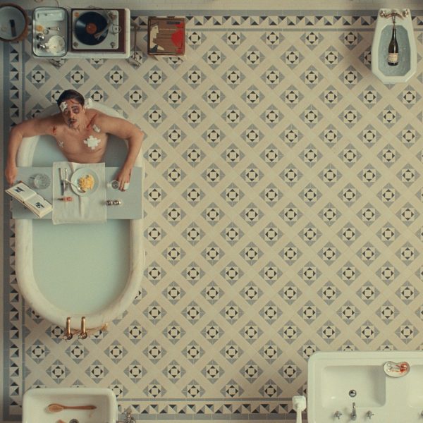 Man in bathtub on a tiled floor