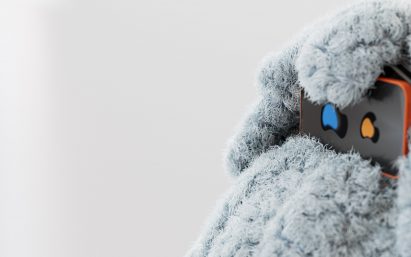 a photograph of a smartphone placed on a blue, soft textured surface
