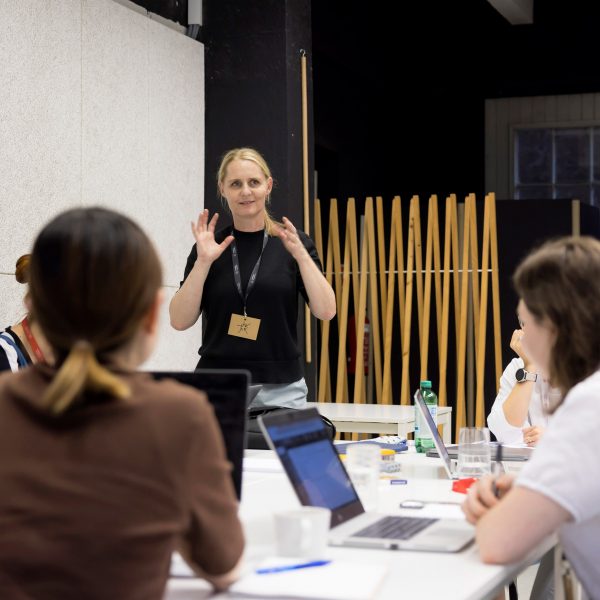 a photograph of students and a lecturer in a classroom