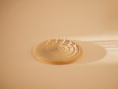 Photo of a ceramic plate with grooves cut into one side and spikes rising up from in between them