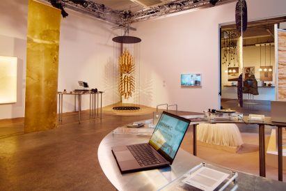 Inside the exhibition depicting a laptop open alongside the exhibits