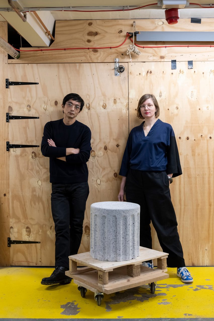Photograph of the designers posing with a stool from the collection.
