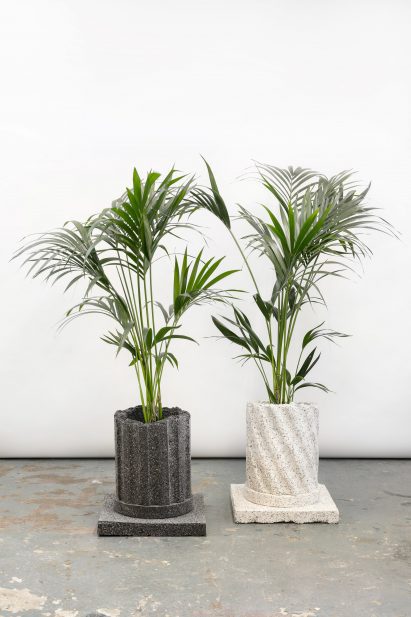 Photograph of two planters from the collection that resemble decaying granite columns.