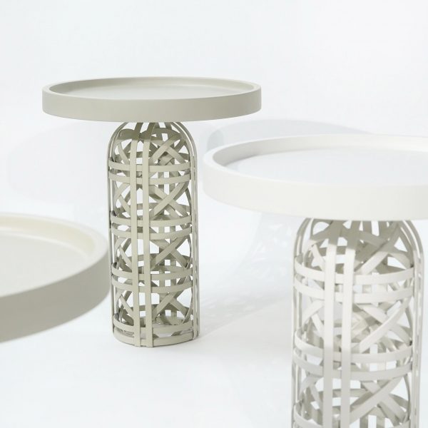 Photo of white side tables with woven bases