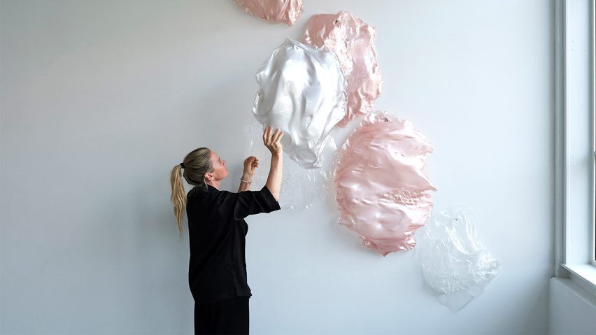 Photo of person arranging tactile art on a wall