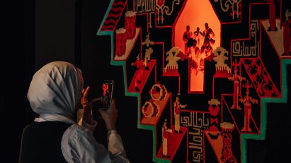 Artwork hanging up on wall that explores Arab wedding traditions