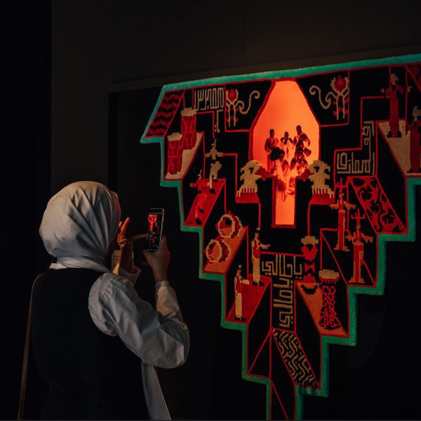 Artwork hanging up on wall that explores Arab wedding traditions