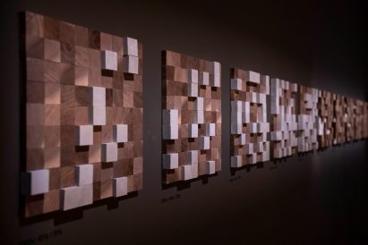 Wooden wall art displayed along gallery wall