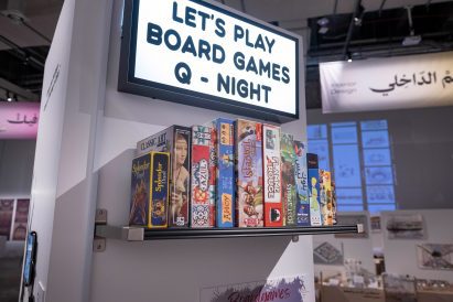 Photo of a sign and board games on a shelf