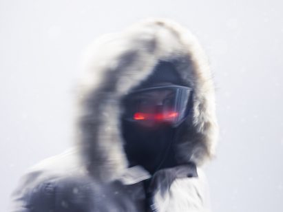 A person in a ski mask and hoodie