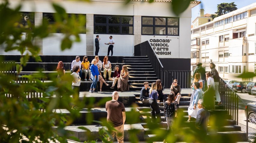 a photograph of athe exterior university campus with students around it