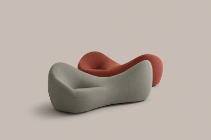 Two curving upholstered benches, one grey and one red
