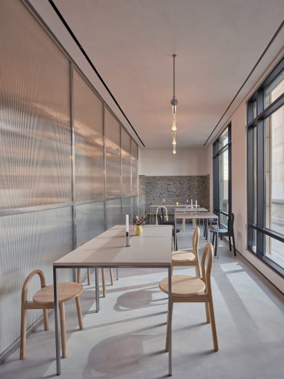 Long, narrow cafe interior with wooden seating