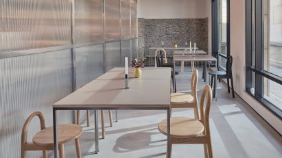 Long, narrow cafe interior with wooden seating