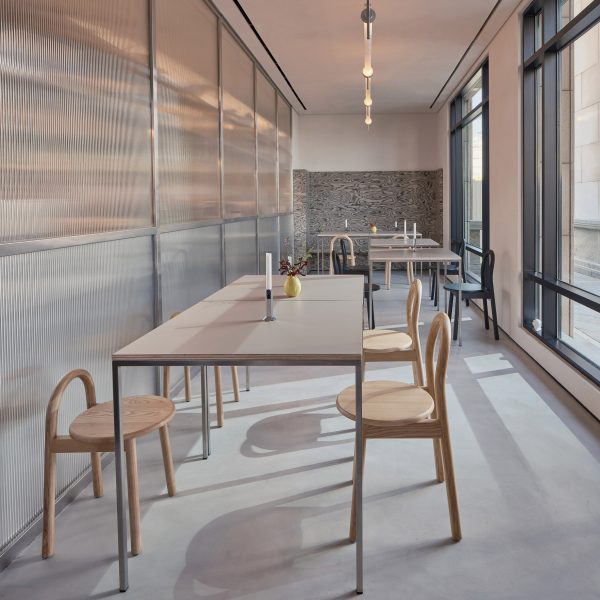 Long, narrow cafe interior with wooden seating