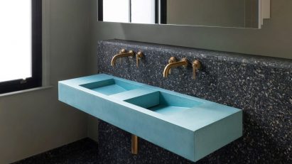 Turquoise sink against dark wall