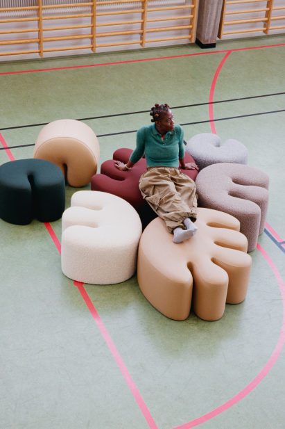 Kusheda Mensah sitting on poufs