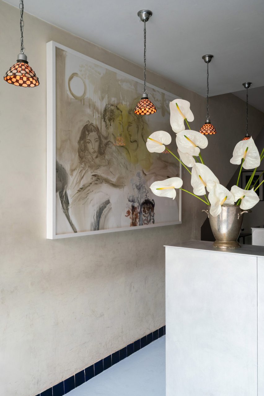 Bar interior with aluminium bar, metal shelving and cafe seating