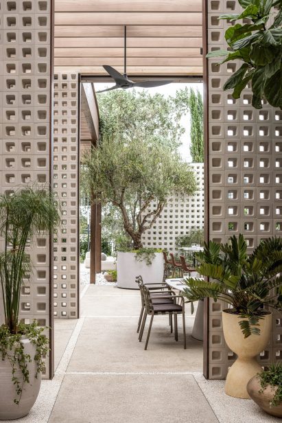 Outdoor dining area divided by perforated block partitions