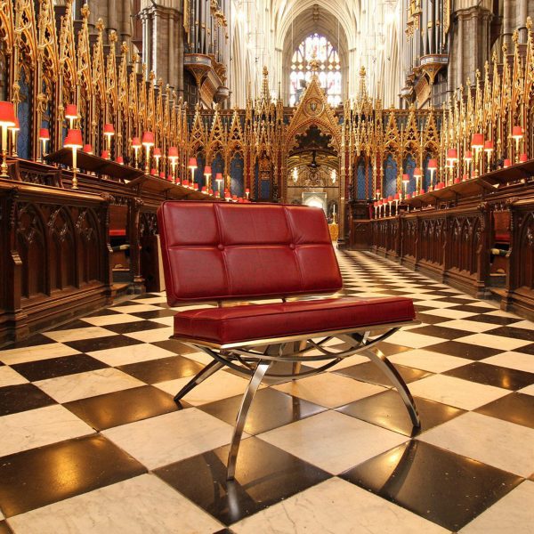 a photograph of a red chair in a church