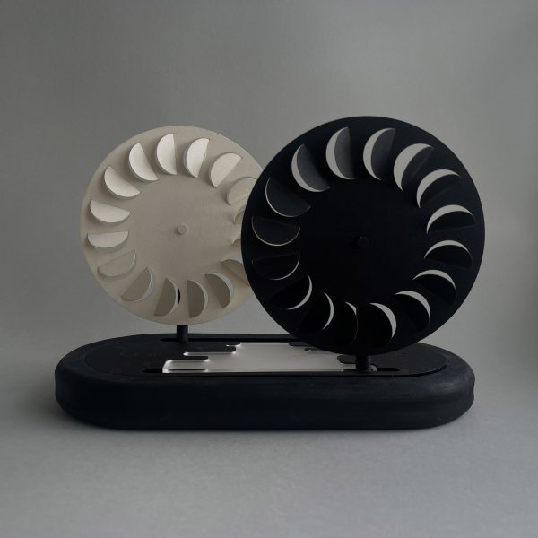 a photograph of two circular fans in tones of white and black