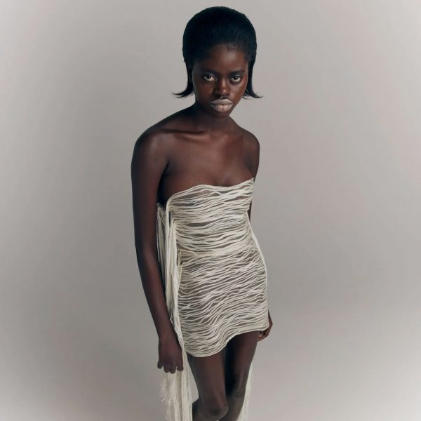 Model wearing a dress made from wool and an algae biomaterial