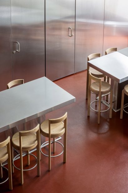 A red-toned, non-slip epoxy floor in a restaurant dining area