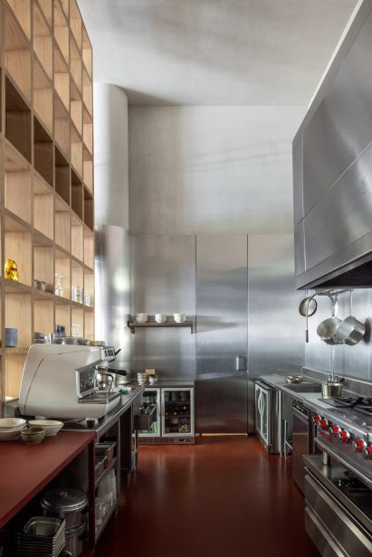 Kitchen with stainless steel walls and red epoxy floor