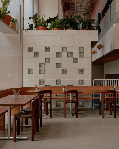 Restaurant interior with glass block wall and wooden furniture