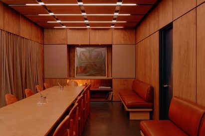 Semi-private dining and listening room lined with plywood panels