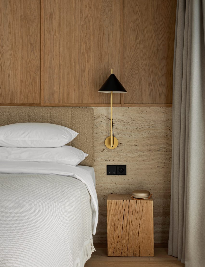 Bedroom with travertine and wood headboard